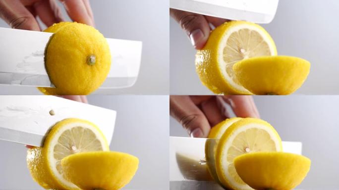 切刀多汁柠檬，在4k分辨率的灰色背景上近距离切片柠檬