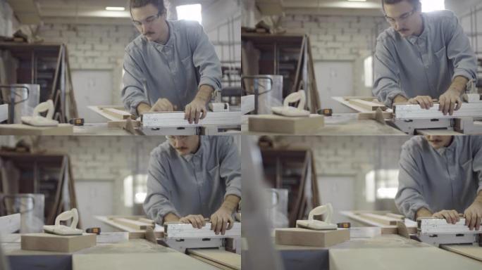 高加索木匠在台锯上定位和切割木头