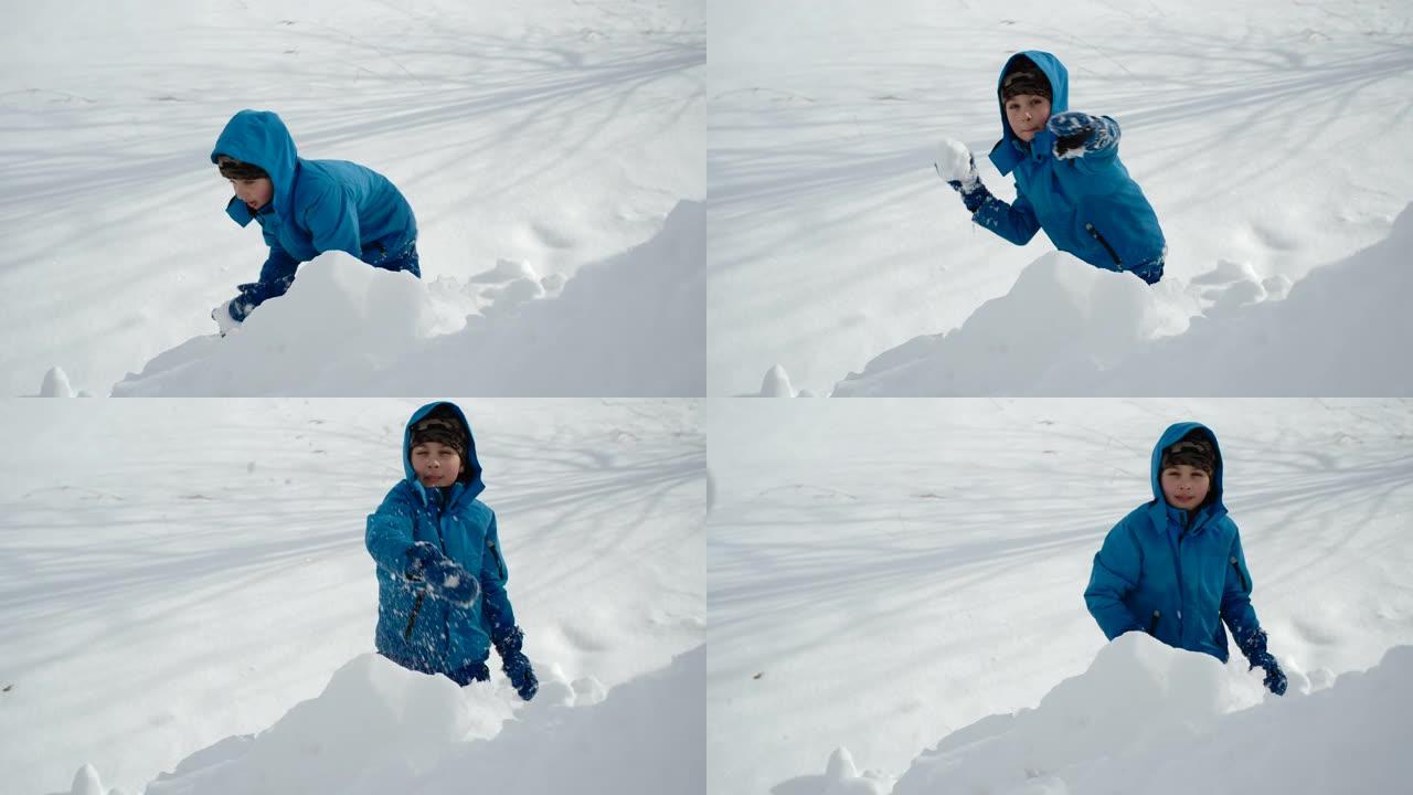 开朗的男孩玩打雪仗玩得开心。慢动作。