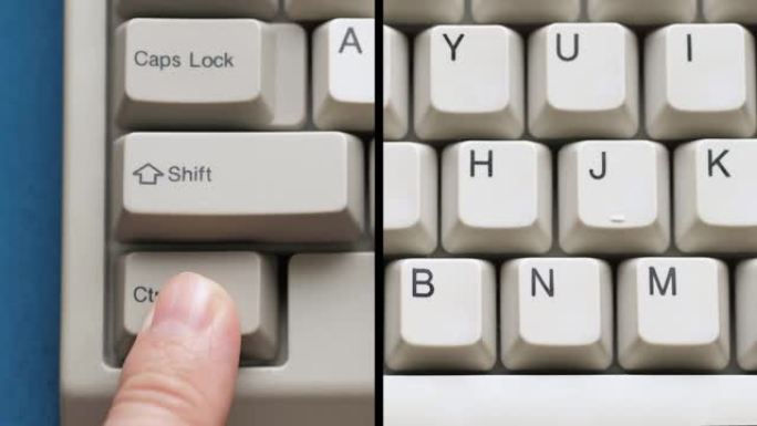 男性手指按下白色键盘上的CTRL N按钮。慢动作和宏观视图