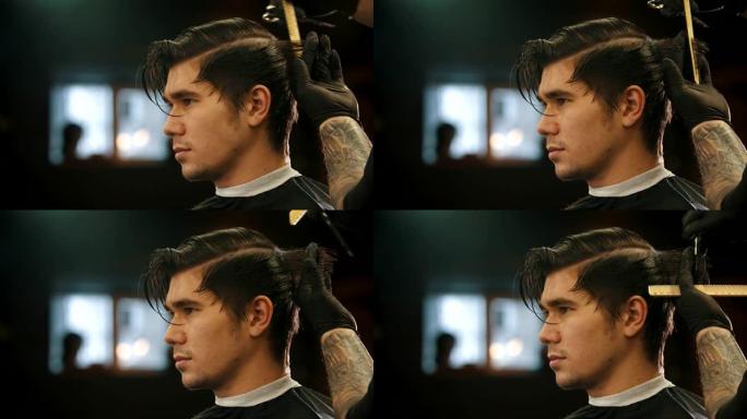 一个年轻的男人在理发店理发，纹身的理发师戴着黑色手套-剪颈背