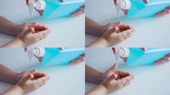 疫情期间，妈妈将液体肥皂倒在孩子的手掌上