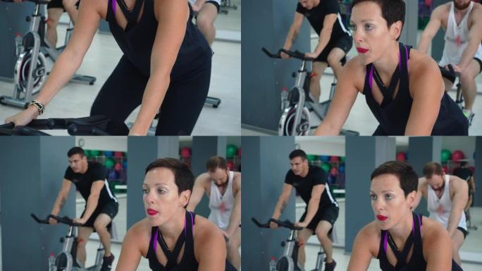 适合女性在自行车课上锻炼室内自行车。健身俱乐部自行车训练中的肖像运动女性。健身人士在体育俱乐部骑自行