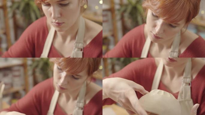 女性工匠用湿手在粘土碗上平滑镂空装饰