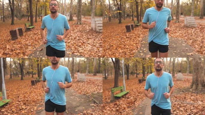 男人在公园慢跑和锻炼。慢动作视频。