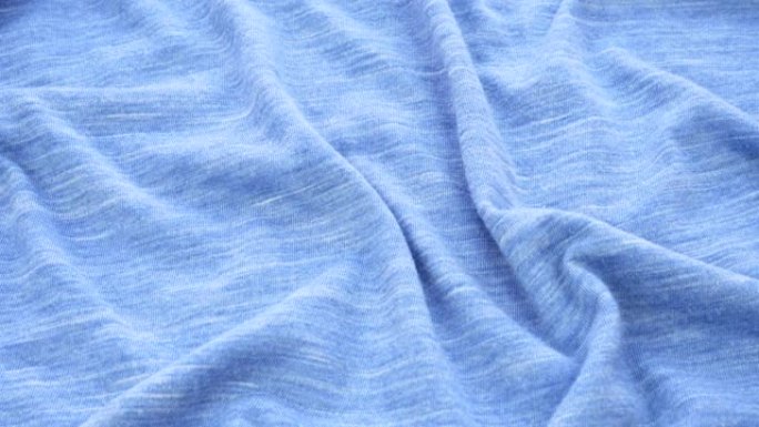 织物特写的明亮蓝色背景。蓝色斑点织物