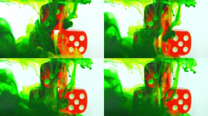 浸入水中的红色赌场骰子与多色油漆染料混合