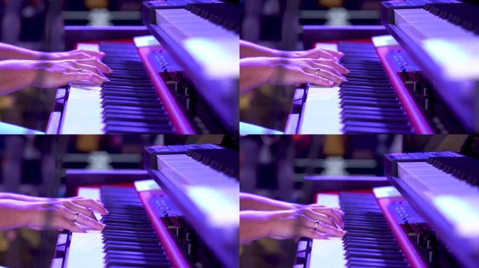 双手放在键盘上慢动作弹奏钢琴。
