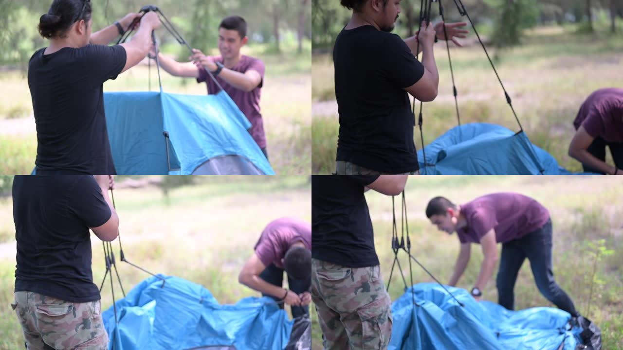 一群朋友，年轻的亚洲男女在森林中露营，两名男性帮助并设置帐篷。露营，旅行和友谊概念