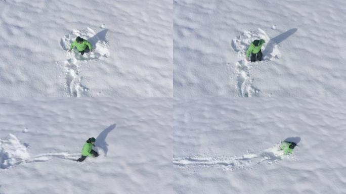 开朗的人害怕，在冬季跑步时在白色的雪堆上逃跑。男子从无人机上坠入雪堆鸟瞰图。顶部鸟瞰图白色蓬松雪中的