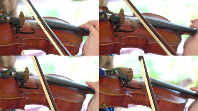 特写拉小提琴的人，街头艺术家。