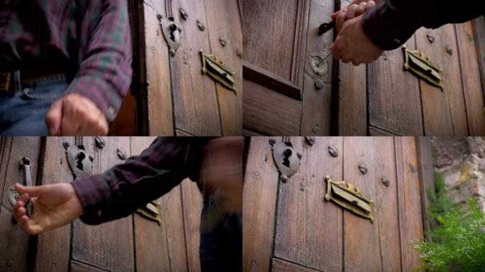 一个男人离开房子并锁上旧木门的低角度