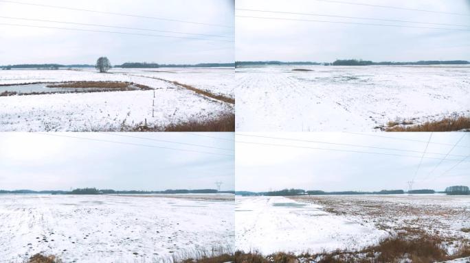 在4k慢动作60fps的冬季，透过窗户在田野上的火车视图