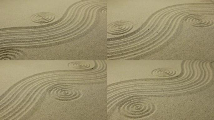 沙质背景，有平滑的波浪和圆圈。滑块镜头。美丽的效果，线条延伸到远处。