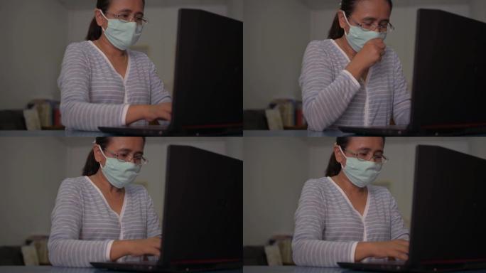 戴着防护面罩的女人在笔记本电脑的桌子上工作。亚洲女性在家里桌子上打字时咳嗽。冠状病毒保护。新型冠状病