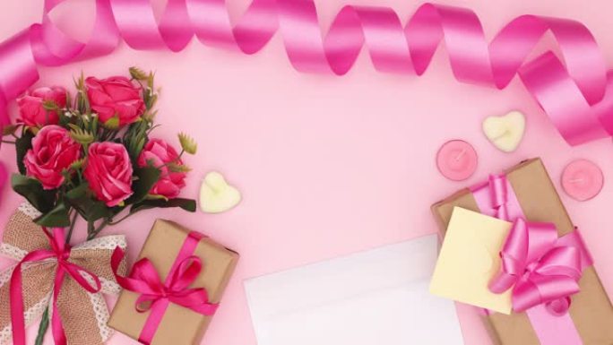情人节，母亲节或妇女节的粉红色背景上的鲜花，礼物和女性配饰-停止运动