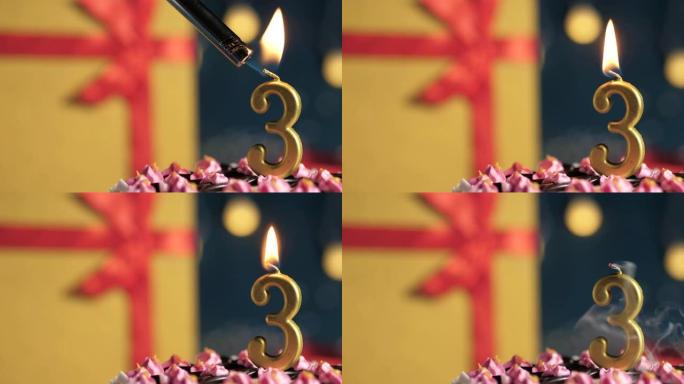 生日蛋糕3号点火器燃烧的金色蜡烛，蓝色背景礼物黄色盒子用红丝带绑起来。特写和慢动作
