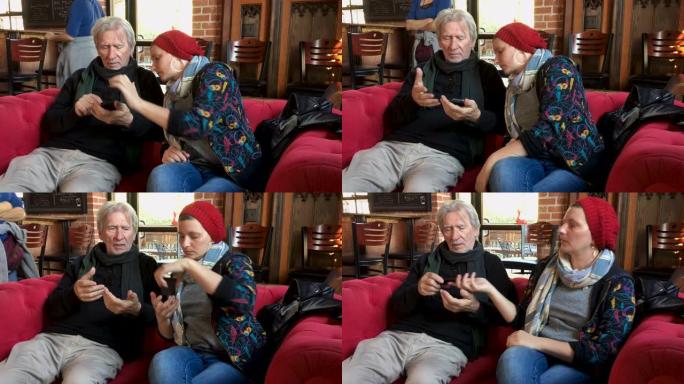 年轻女子展示一个年长的男人如何使用他的手机
