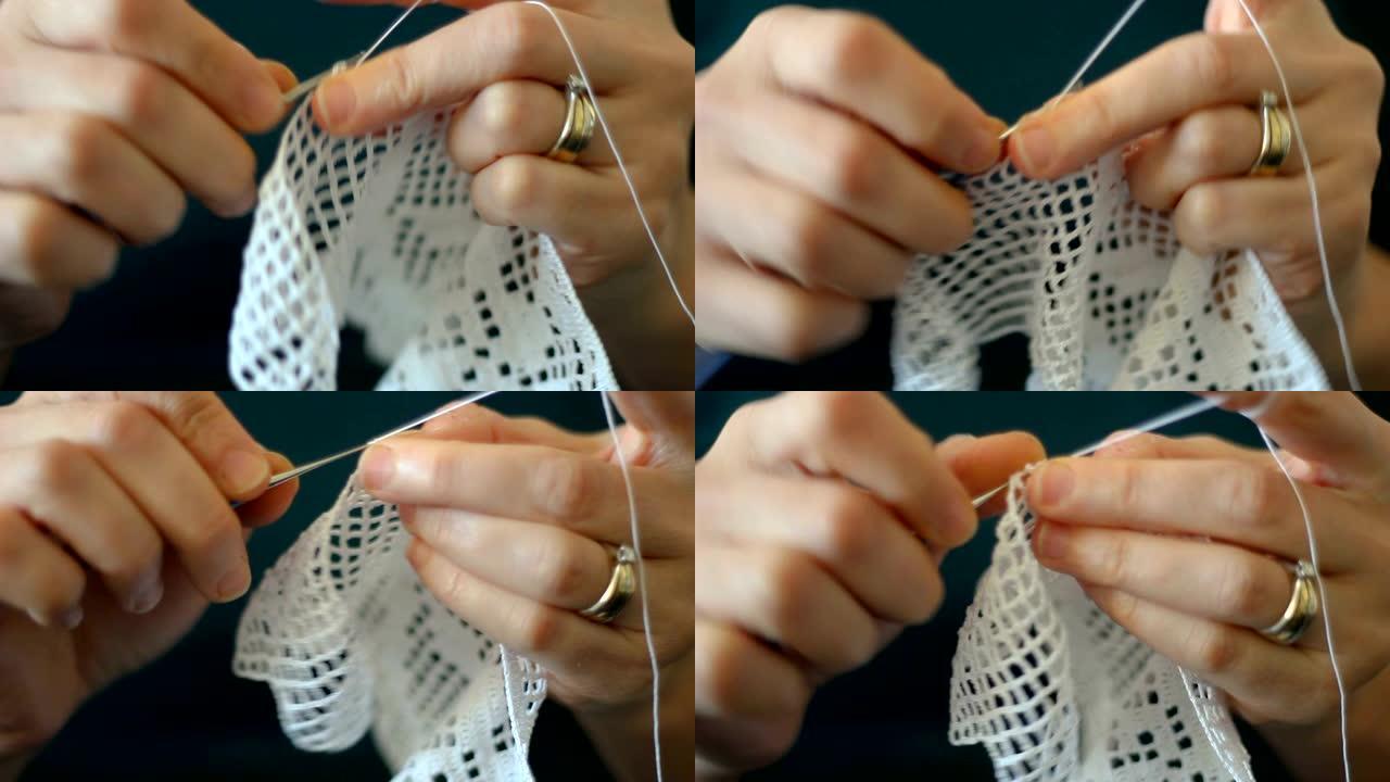 手工制作的传统针织。女人用缝纫针做帆布图案针。用螺纹覆盖