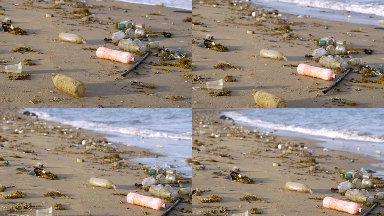 塑料瓶在海滩的海岸线和海洋中乱扔垃圾