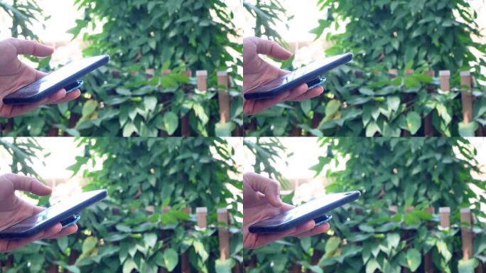 用智能手机在花园里近距离接触。