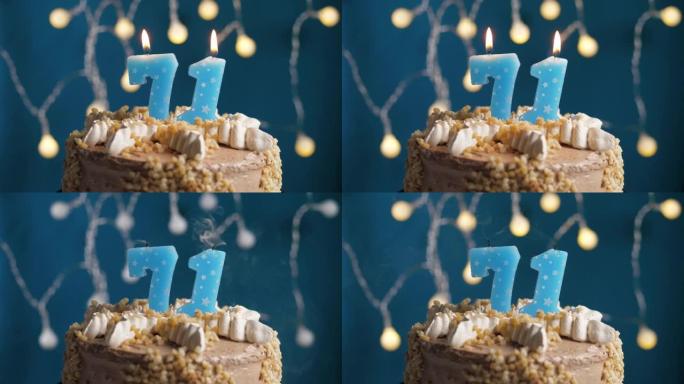 蓝色背景上有71号蜡烛的生日蛋糕。蜡烛吹灭了。慢动作和特写视图