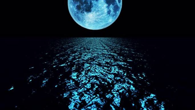 蓝色的月亮在夜晚在海洋上缓慢落下