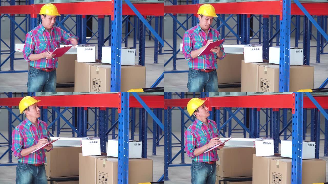 亚洲男子工头看着顶部货架上的纸盒，用于检查仓库中的货物