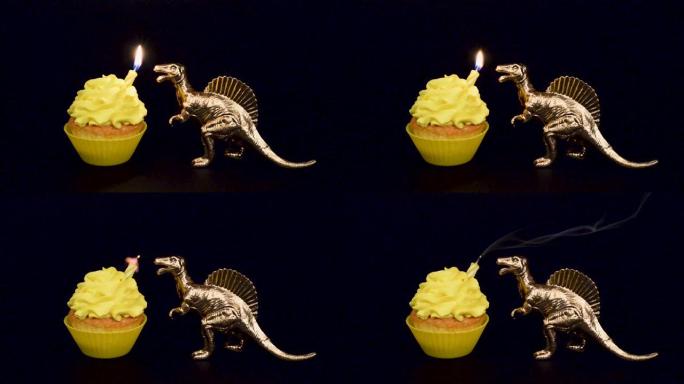 金色恐龙在黑色背景上隔离的亮黄色纸杯蛋糕上吹出蜡烛。生日快乐概念。高清视频。生日蛋糕和玩具恐龙
