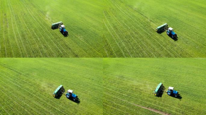 田间拖拉机上的农民为农作物施肥以提高生产力