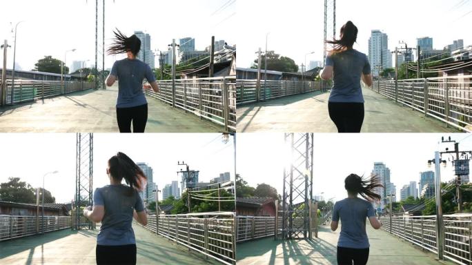 女性高加索亚裔运动员在城市的街道上跑步。日落时在街上训练有氧慢跑锻炼生活方式。健康的生活方式。