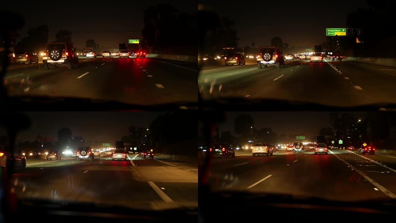 从车里看。洛杉矶夜间繁忙的高速公路。美国加利福尼亚州的大规模州际公路。在高速公路车道上快速行驶。交通