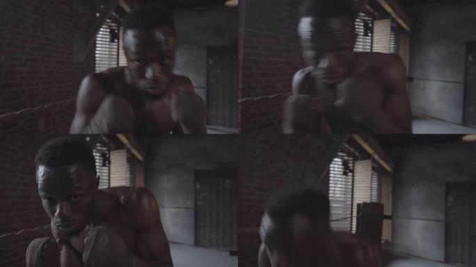 年轻的黑人拳击手在搏击俱乐部练习防御动作