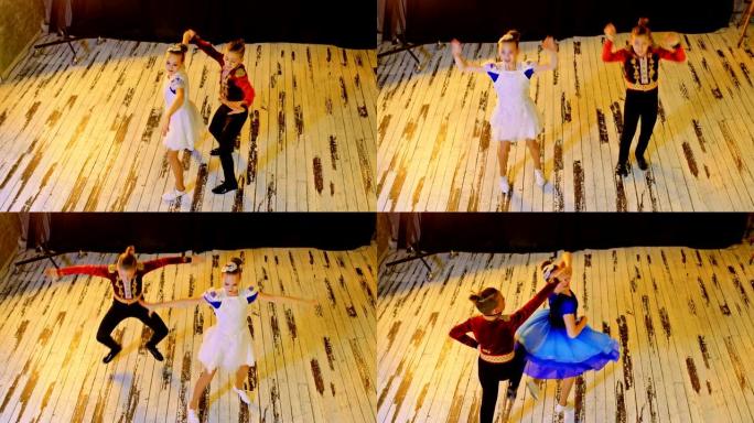 运动员一个男孩和一个女孩以西班牙风格跳舞。男孩和女孩踢得很高，转过身来。壮观的舞蹈在明亮的工作室，训