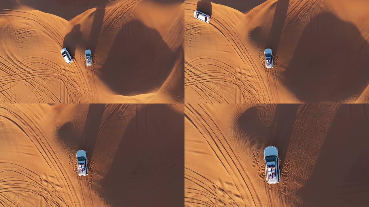 空中。年轻夫妇在沙漠的车顶上放松的俯视图。