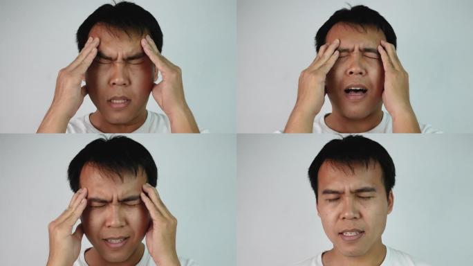 特写严肃的亚洲男人闭上眼睛，擦着头的肖像，在灰色背景上表示沮丧和压力。情感和表达概念。