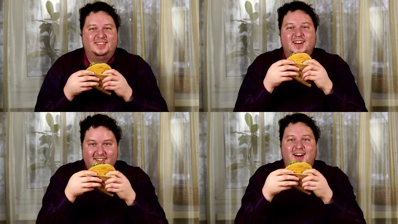 拿着三明治的年轻人。胖子吃快餐。玉米饼不是有益的食物。非常饿的家伙。