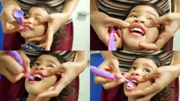 亚洲妈妈早上在浴室刷牙学龄前可爱的小女孩牙齿