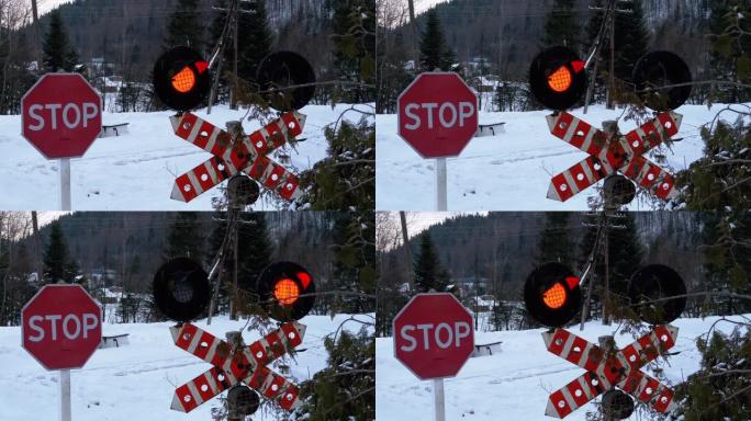 冬天，森林中的铁路道口红色闪烁的交通信号灯。火车经过