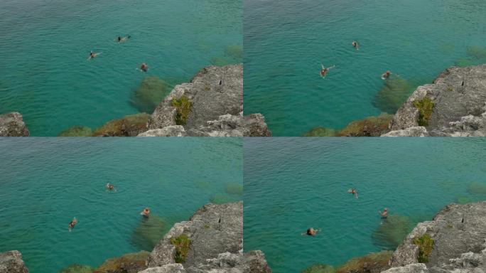 三人在加拿大布鲁斯半岛的清澈水域中游泳