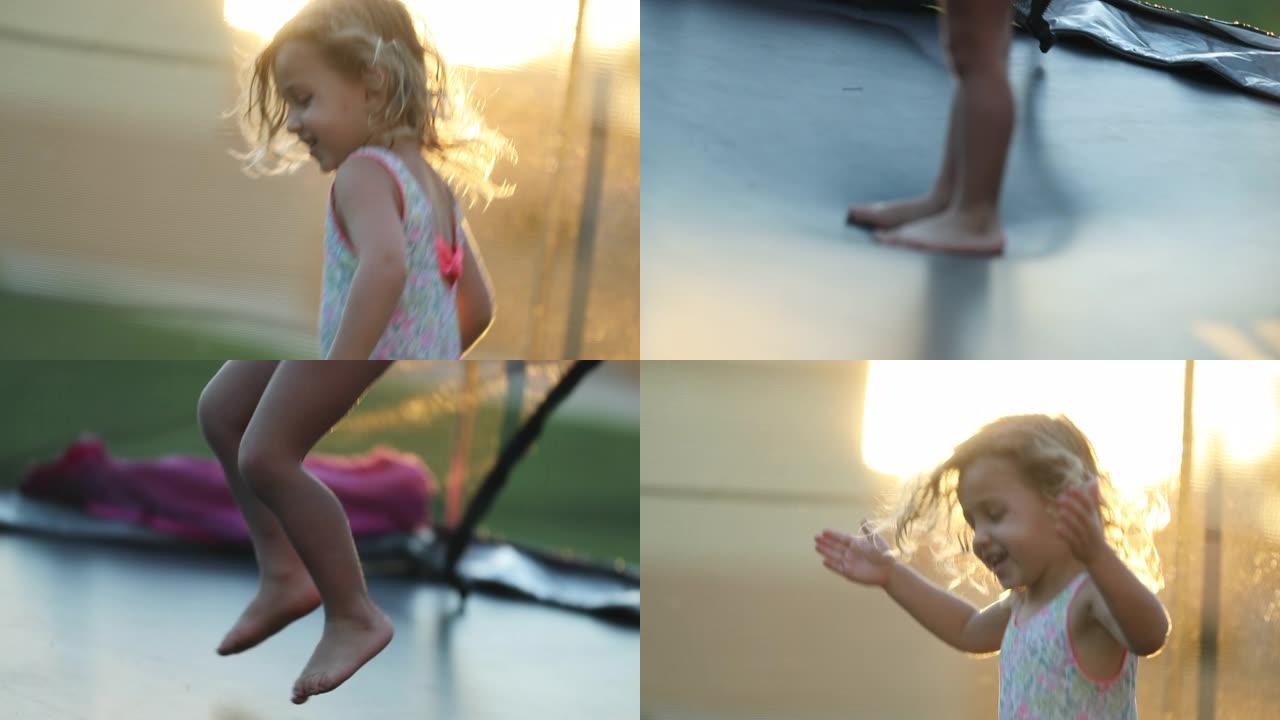 快乐的小女孩在蹦床上蹦蹦跳跳，感到快乐