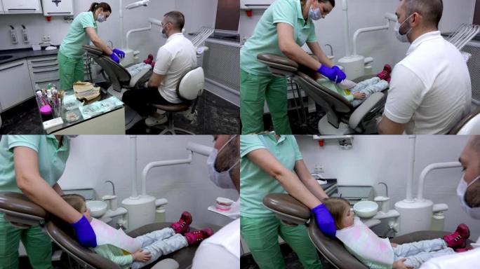 护士正在准备一个可爱的小女孩进行牙科检查