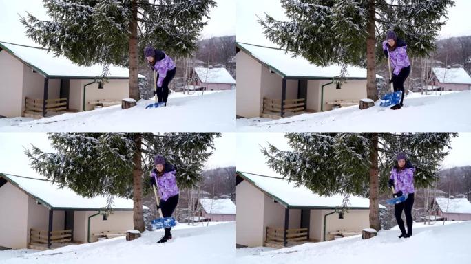 年轻女子在冬天打扫后院