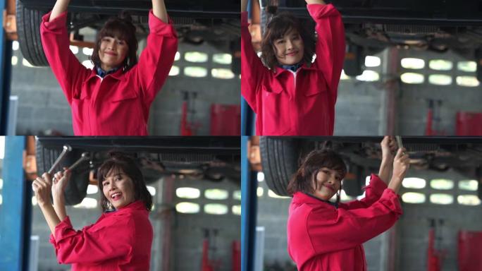 年轻的女技术员在车库里开心地微笑和跳舞，一整天的努力工作后放松