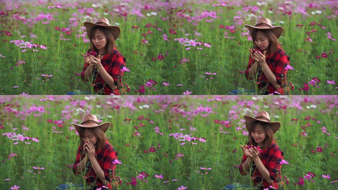 亚洲成熟女性在宇宙草地上的面部表情，手在花上奔跑