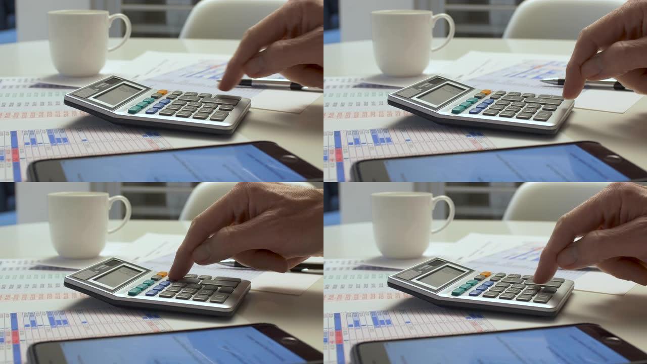 用计算器做账的人在桌面上做账。