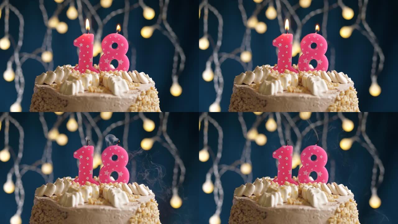 蓝色背景上有18号粉色蜡烛的生日蛋糕。蜡烛吹灭了。慢动作和特写视图
