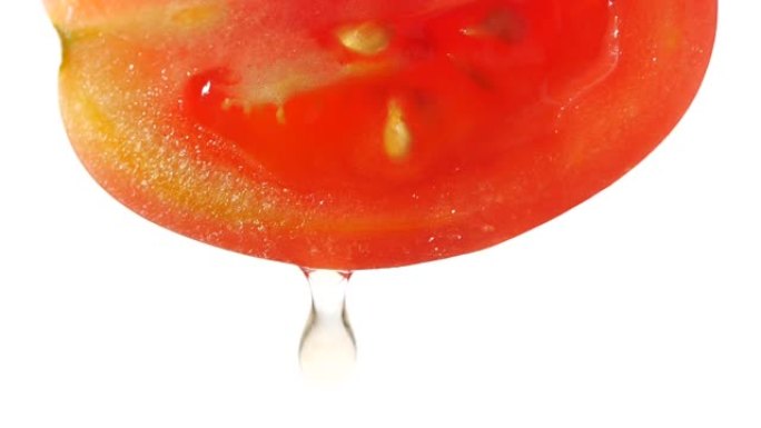 慢动作从白色背景上的番茄片中滴落的水或果汁，用于饮食和健康食品的番茄汁