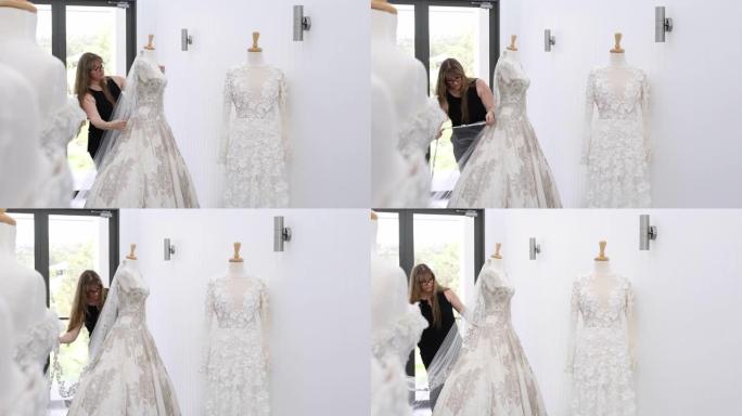 时装设计师调整人体模型上的婚纱