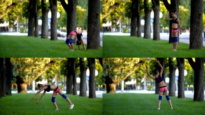 一个阳光明媚的夏日，在城市公园的草地上，穿着运动服的七年美丽的高加索女孩练习体操。慢动作